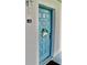 Charming unit entrance with a welcoming blue door and decorative wreath at 2737 Enterprise E Rd # 192, Clearwater, FL 33759