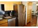 Kitchen featuring stainless steel appliances, including refrigerator and dishwasher, and modern wood cabinetry at 2737 Enterprise E Rd # 192, Clearwater, FL 33759