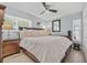 Comfortable bedroom with hardwood floors, a ceiling fan, and plenty of natural light from the windows at 2824 Paddock Dr, Palm Harbor, FL 34684
