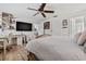 Comfortable bedroom with hardwood floors, ceiling fan, and a built in desk at 2824 Paddock Dr, Palm Harbor, FL 34684