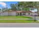 Charming single-story home with a well-manicured lawn and stone accents at 2824 Paddock Dr, Palm Harbor, FL 34684