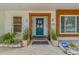 Inviting front entrance with a decorative door, lush plants, and a well-maintained walkway at 2824 Paddock Dr, Palm Harbor, FL 34684