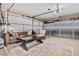 This garage is decorated like a living room and features a brown leather sofa and metallic storage cabinets at 2824 Paddock Dr, Palm Harbor, FL 34684