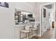 Modern kitchen with white cabinets, stainless steel appliances and breakfast bar at 2824 Paddock Dr, Palm Harbor, FL 34684
