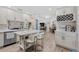 Bright open kitchen featuring white cabinets, stainless steel appliances, and a center island with seating at 2824 Paddock Dr, Palm Harbor, FL 34684