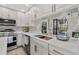 Well-lit kitchen featuring white cabinets, stainless steel appliances and granite countertops at 2824 Paddock Dr, Palm Harbor, FL 34684