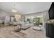 Bright living room featuring a large window offering a view of the pool at 2824 Paddock Dr, Palm Harbor, FL 34684