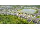 An aerial view of the neighborhood showcasing the homes, landscaping, and a nearby pond at 2898 Living Coral Dr, Odessa, FL 33556