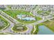 Aerial view showcasing community amenities including pools, playgrounds, green spaces, and surrounding residences at 2898 Living Coral Dr, Odessa, FL 33556