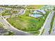 Aerial view of community amenities, including a pool and playground next to single Gathering homes at 2898 Living Coral Dr, Odessa, FL 33556