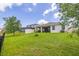 A well-maintained backyard with fence, featuring a covered patio and space for outdoor activities at 2898 Living Coral Dr, Odessa, FL 33556