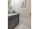 Neutral-toned powder room featuring modern vanity with granite counter, and tile floors at 2898 Living Coral Dr, Odessa, FL 33556