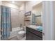 Bathroom featuring a shower/tub combination with a blue patterned shower curtain at 2898 Living Coral Dr, Odessa, FL 33556