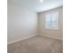 Bedroom featuring carpet flooring, base molding, and a window with plantation shutters at 2898 Living Coral Dr, Odessa, FL 33556