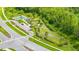 Aerial view of a community dog park and play area nestled among lush greenery and trees at 2898 Living Coral Dr, Odessa, FL 33556