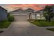 Charming single-story home featuring a well-maintained lawn, two-car garage, and lovely landscaping at 2898 Living Coral Dr, Odessa, FL 33556