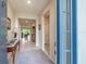 Inviting foyer featuring neutral tile flooring, a console table, and views into the living areas at 2898 Living Coral Dr, Odessa, FL 33556