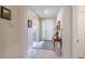 Hallway featuring neutral paint, tile floors, and a decorative console table at 2898 Living Coral Dr, Odessa, FL 33556