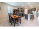 Eat-in kitchen with modern appliances, granite countertops, and adjacent dining area for casual and formal meals at 2898 Living Coral Dr, Odessa, FL 33556