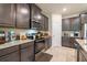 Well-equipped kitchen with stainless steel appliances and granite countertops, perfect for cooking and entertaining at 2898 Living Coral Dr, Odessa, FL 33556