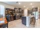 Open-concept kitchen with granite countertops, large island and seating, stainless steel appliances, and stylish cabinetry at 2898 Living Coral Dr, Odessa, FL 33556