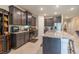 Well-appointed kitchen features a central island, granite countertops, stainless steel appliances, and ample cabinet space at 2898 Living Coral Dr, Odessa, FL 33556