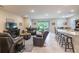Spacious living room open to the kitchen featuring comfortable seating and ample natural light at 2898 Living Coral Dr, Odessa, FL 33556