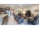 Open-concept living area seamlessly connects to kitchen with island seating and modern stainless steel appliances at 2898 Living Coral Dr, Odessa, FL 33556