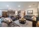 Open-concept living area with hardwood floors, stylish furnishings, and abundant natural light, connecting to kitchen at 2898 Living Coral Dr, Odessa, FL 33556