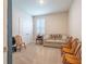Cozy living room with carpet, sofa and three chairs at 2898 Living Coral Dr, Odessa, FL 33556