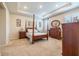 Spacious main bedroom featuring tray ceiling, carpet flooring, and traditional-style wood furniture at 2898 Living Coral Dr, Odessa, FL 33556