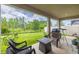 Covered patio featuring comfortable seating, a fire pit, and views of the lush backyard at 2898 Living Coral Dr, Odessa, FL 33556
