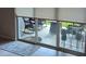 Sliding glass doors lead to a patio with rocking chairs and plants on stands at 2898 Living Coral Dr, Odessa, FL 33556