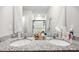 Bathroom featuring double sinks with granite countertops and a large mirror at 3082 Forrest Plum Ct, Zephyrhills, FL 33540