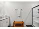 Modern bathroom with a walk-in shower and a wood bench at 3082 Forrest Plum Ct, Zephyrhills, FL 33540