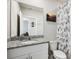 Bright bathroom featuring a granite countertop, stylish decor, and a decorative shower curtain at 3082 Forrest Plum Ct, Zephyrhills, FL 33540