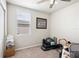 Neutral-toned bedroom features natural light, a ceiling fan, and plenty of space at 3082 Forrest Plum Ct, Zephyrhills, FL 33540