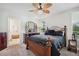 Comfortable bedroom with a large bed, dresser, and an ensuite bathroom with modern finishes at 3082 Forrest Plum Ct, Zephyrhills, FL 33540