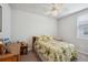 Comfortable bedroom with tropical-themed decor and a ceiling fan at 3082 Forrest Plum Ct, Zephyrhills, FL 33540