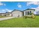 Inviting one-story home with a lush lawn, complemented by tasteful landscaping and a two-car garage at 3082 Forrest Plum Ct, Zephyrhills, FL 33540