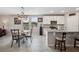 Eat in kitchen featuring a granite island, stainless appliances, and a pendant dining set at 3082 Forrest Plum Ct, Zephyrhills, FL 33540