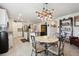 Bright kitchen featuring stainless steel appliances and a stylish dining area with modern light fixture at 3082 Forrest Plum Ct, Zephyrhills, FL 33540