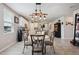 Bright kitchen featuring stainless steel appliances and a stylish dining area with modern light fixture at 3082 Forrest Plum Ct, Zephyrhills, FL 33540