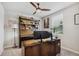 Comfortable office space with a wooden desk, modern lighting, and a ceiling fan at 3082 Forrest Plum Ct, Zephyrhills, FL 33540
