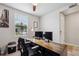 Well-lit home office featuring a modern desk, dual monitors, and a comfortable workspace at 3082 Forrest Plum Ct, Zephyrhills, FL 33540