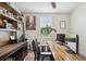 Comfortable office space with a wooden desk, modern lighting, and built-in shelving at 3082 Forrest Plum Ct, Zephyrhills, FL 33540