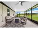 Inviting screened patio with comfortable seating and views of a lush green landscape at 3082 Forrest Plum Ct, Zephyrhills, FL 33540