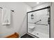 Modern walk-in shower with a black frame and built in seat at 3082 Forrest Plum Ct, Zephyrhills, FL 33540