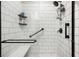 Accessible walk-in shower with grab bars and a built-in seat at 3082 Forrest Plum Ct, Zephyrhills, FL 33540