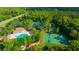 Aerial view of community amenities including a pool, tennis and basketball courts, and playground at 31814 Larkenheath Dr, Wesley Chapel, FL 33543